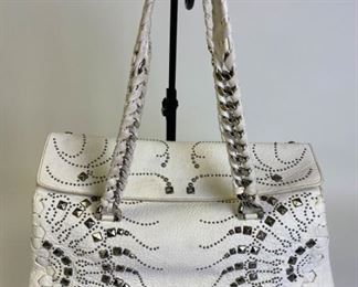 Lot	239	Roberto Cavalli White Silver Studded Purse	Roberto Cavalli Regina Radiant studded satchel bag in lambskin leather with inlaid chain and leather handles, internal zip and slip pockets, microfiber lining and silver tone hardware detail. Made in Italy. Some discoloration on handles, minor marks on outside, pen marks on inside lining and inside flap 14" l x 10.5" w x 6" d
