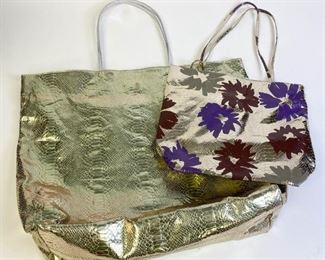 Lot	251	Grouping of Two Carlos Falchi Barbarella Totes	Lot includes two Carlos Falchi gold snakeskin -look microfiber totes with matching zippered pouch; gold lone tote with satin floral lining, magnetic closures, measures 18"L x 6"W x 19"D, smaller gold snakeskin-look microfiber tote with floral design lined in green with Falchi by Falchi label measures 11"L x 4"W x 12"D, minor marks and wear, good condition

