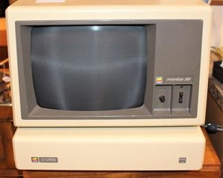Vintage Apple Macintosh computer.  Monitor, keyboard and floppy drives.  