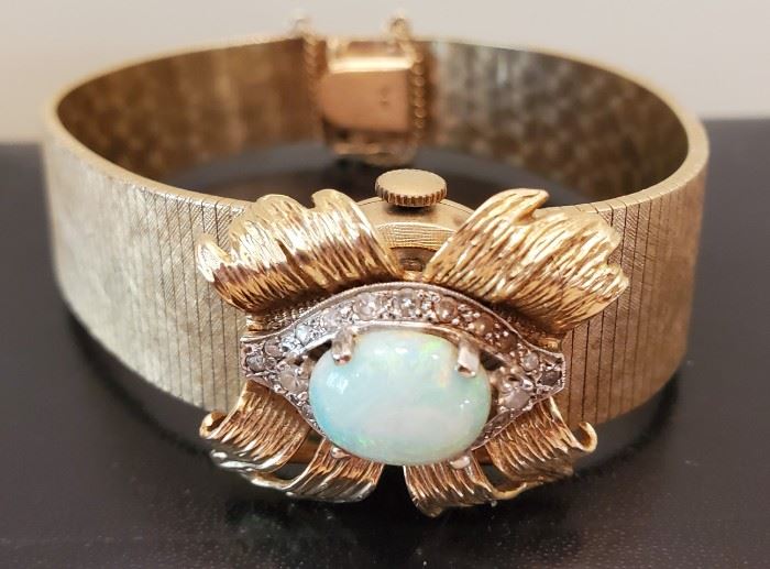Gold and opal Geneva watch or use as a bracelet.