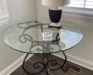 Lot 5507 $175.00 Beveled Glass Top Side/Foyer Table with Wrought Iron Base. 36"round x 31"h Lamp is available in a later lot.