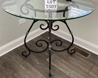 Lot 5507 $175.00 Beveled Glass Top Side/Foyer Table with Wrought Iron Base. 36"round x 31"h Lamp is available in a later lot.