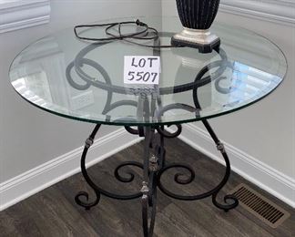 Lot 5507 $175.00 Beveled Glass Top Side/Foyer Table with Wrought Iron Base. 36"round x 31"h Lamp is available in a later lot.
