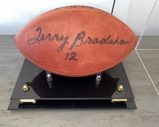 Lot 5514. $225.00. Terry Bradshaw Signed Football, in Sharp Acrylic Footed Case, measures 12.5" long, 8" wide x 9.5" tall. No COA, but nice clear signature, Perfect for your Man Cave!