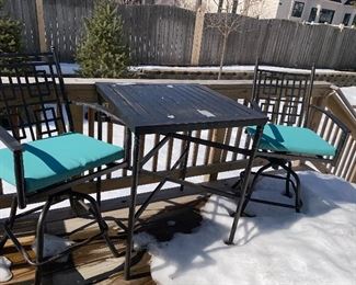 Lot 5516. $85.00. Outdoor Bistro Table and Two Swivel Chairs. The tabletop needs to be scraped and spray painted, the two chairs are in good shape, they come with two turquoise chair pads. Bistro table height.