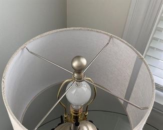 Lot 5550. $40.00. Cute table lamp with fabric shade; the lamp is black with platinum accents. 23" t on a 7" x 5" base; the lampshade is 11" in diameter.