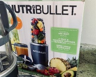 Lot 5540. $26.00 Nutribullet set with box, includes; power base, short cup with a handled ring, tall cup, extractor blade, 1 lip ring, and a care booklet.