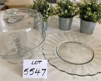 Lot 5547. $40.00 14" diam glass cake plate and a dome-covered pedestal cake plate (tiny chip on edge of pedestal plate.)