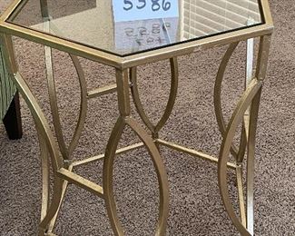 Lot 5586. $95.00 Goldtone metal tubular base with hexagon-shaped glass side table. Only one available.