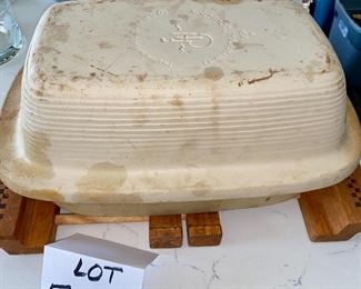 Lot 5553. $60.00 Pampered Chef Family Heritage stone baker with cover and sits on an expandable wood-handled trivet. Note: do not be alarmed by the discolorations on this piece - every one of them gets like this upon using only once!