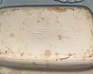Lot 5553. $60.00 Pampered Chef Family Heritage stone baker with cover and sits on an expandable wood-handled trivet. Note: do not be alarmed by the discolorations on this piece - every one of them gets like this upon using only once!