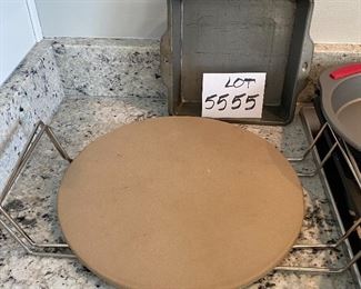 Lot 5555. $35.00 This lot features a "like new" 13" Pampered Chef pizza stone and two metal carrying racks; 2 Food Network Pie Pans and an 8" square metal dish.