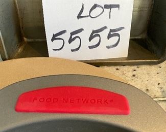 Lot 5555. $35.00 This lot features a "like new" 13" Pampered Chef pizza stone and two metal carrying racks; 2 Food Network Pie Pans and an 8" square metal dish.