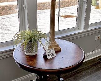 Lot 5503. $175.00. Cute Round Lamp Table with Burlwood parquetry top, Metal legs on a triangular base. Tabletop is 28" in diameter, height 29". (Lamp and plant are grouped in Lot 5508)