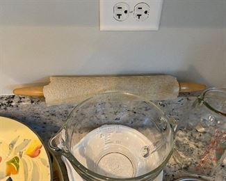 Lot 5572. $40.00 Pampered Chef 2 Qt - 8C measuring bowl with lid in excellent condition; 2) Polished metal Banana holder ; 3). Cute Vintage Glasco measuring pitcher with mixing pump. 4 ) Cloth Covered Rolling Pin