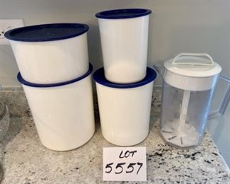 Lot 5557. $20.00. Tupperware Canister Set of 4 - white with blue lids with scoops, Pampered Chef Pitcher with plunge-action mixer for frozen O.J. or similar. This lot of items are well-used, but with a lot of life still left in them.