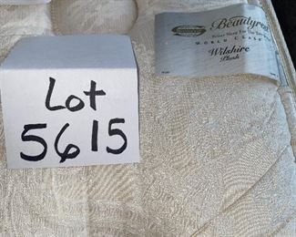 Lot 5615. $425.00. Queen Bed, With Nailhead and Fabric Headboard, Ralph Lauren premier mattress pad, comforter (Duvet?), 4 pillows and shams (2 are Euro) pillowtop mattress by Beauty Rest Wilshire Plus comfortable.