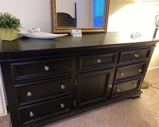 Lot 5603. $1,625.00 King Bedroom Set Includes Pennsylvania House Steve Tyrell Collection King 2 poster Headboard, (see index card following for story) Footboard and Frame, 73" tall, a tall Black chest dresser 38"w x 19" d, x53" tall 6 drawers; not branded, and 7 drawer dresser with cabinet with 2 drawers, 66" x 19" d x 33.5" unbranded as well, also in Black.