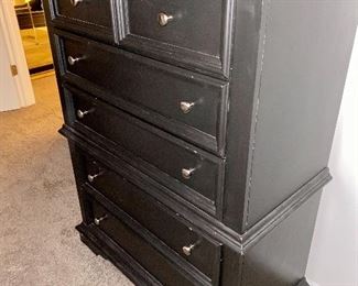 Lot 5603. $1,625.00 King Bedroom Set Includes Pennsylvania House Steve Tyrell Collection King 2 poster Headboard, (see index card following for story) Footboard and Frame, 73" tall, a tall Black chest dresser 38"w x 19" d, x53" tall 6 drawers; not branded, and 7 drawer dresser with cabinet with 2 drawers, 66" x 19" d x 33.5" unbranded as well, also in Black.