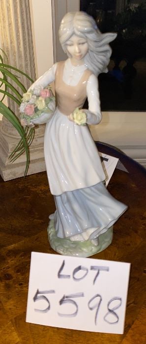 Lot 5598 $40.00. Tengra Girl Figurine holding a basket of flowers. 11"x5"w. Tengra is a similar manufacturer to Lladro - made in Spain; it's all in the clay.