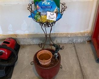 Lot 5627 $45.00 Garden Special (Spring Please Arrive Early!) includes: Wrought Iron Plant Stand; Large Brown Ceramic Pot, 2 Green Knee Pads, Nozzle and 2 Sprinklers, another terra cotta smaller pot