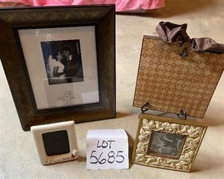 Lot 5685 $25.00 Picture Frame Lot 1: 1) 8"x10" wood embossed picture frame 2) 9" x 9" Clip Picture Frame with Bow on Top