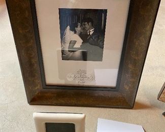 Lot 5685 $25.00 Picture Frame Lot 1: 1) 8"x10" wood embossed picture frame 2) 9" x 9" Clip Picture Frame with Bow on Top