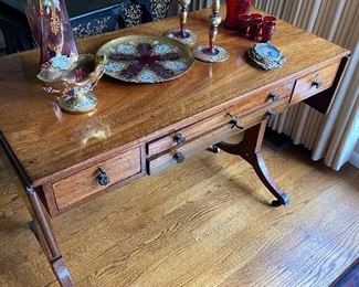 Antique desk or entry table with two dropleaf ends. Cherry. Desk measures 37 inches wide by 18  and 1/4 inches deep by 28 inches high.  When extended each leaf adds 8.5 inches on each end.  $570