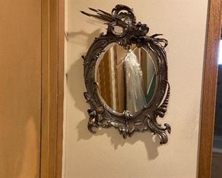 Antique metal framed mirror. 25" h X 17" w. $320