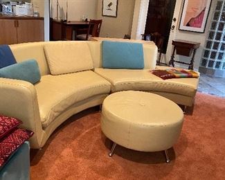 Leather curved sectional by American Leather.  One section is 76" L the other is 84" L with curve it is approx. 134" X 33" d X 30.5" h. Sold with  Thayer Coggins round ottoman 30.5" in diameter by 16.5"h. Excellent condition $1,600 for the set.  Original bookcases are also for sale and included with the price.