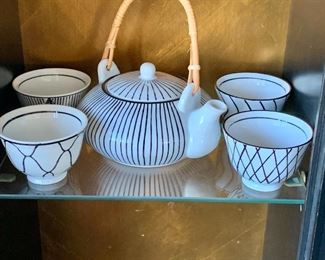 $65 - Ceramic tea set (tea pot with four cups). Teapot: 7"H (with handle) x 7"W x 6.5"D; cups: 2.5"H x 3.5"D