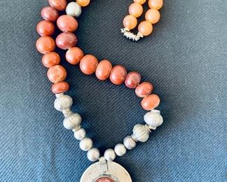 $100 - Tribal multi bead necklace with pendant; silvertone, wood and stone beads enhanced by silver coin hammered pendant; 22” beaded necklace, 3” pendant