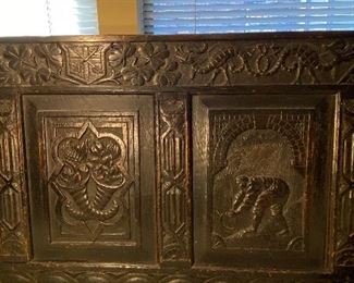 Close up on carved inset on antique bench