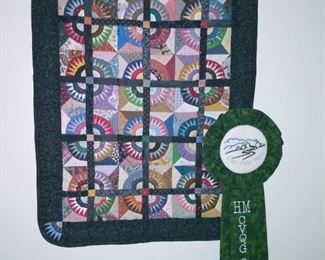 One of Carol's hand stitched wall hanging quilts with its award.
