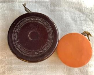$20 each Bakelite and lucite tape measures.  Brown: 2.2"D.  Small: 1.5"D