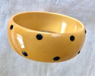 $75 Bakelite polka dot yellow bangle bracelet.  2.5"D 