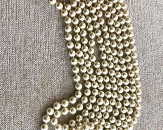 $40 Two matching  faux pearl necklaces connected together to make one extremely long  necklace.  50"L each.