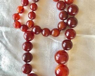 $85 Extra long deep red bakelite beaded necklace.  Has matching earrings to the left of this photo $25 