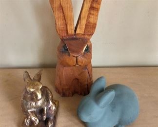 $25 Wood rabbit (back): 10" H, 4" W, 4" D. $20 each Gray resin rabbit (right front): 4" H, 6" W, 4" D.