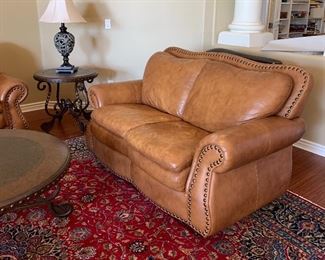 Pleather Rolled Arm Sofa, Loveseat, Chair and Ottoman, Coffee Table, End Tables and Sofa Table w Nailhead Accent, Area Rug, Table Lamps