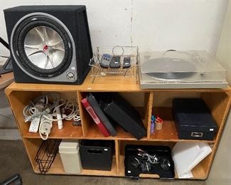 Vintage shelf unit, miscellaneous office items, turn table and a Kicker subwoofer.