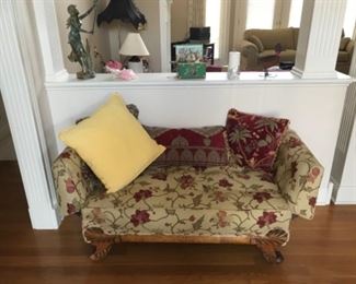 Vintage settee with arms that fold down. Beautiful craftsmanship on the claw feet and upholstery. 