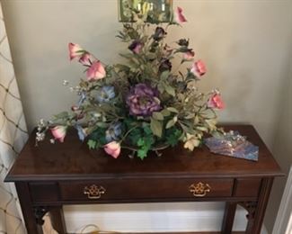 Sofa table and silk flower arrangement. 