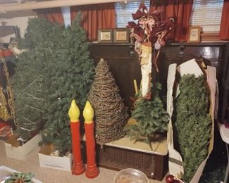 Multiple artificial Christmas trees, plastic candlestick lawn ornaments, more bows and decor