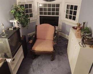 Antique chair, Harley-Davidson television, her speakers, white storage units