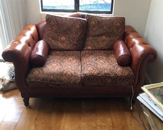 large leather loveseat. Some wear to the leather behind the cushions. Solid piece of furniture.