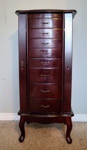 Wooden Jewelry Storage Cabinet. There is scratches/damage as pictured. Measures 14" x 17" and 40" high.
