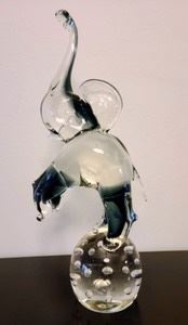 Art Glass Elephant of an elephant elegantly balancing on a glass ball. Pretty piece with no observed chips or cracks. Measures about 5” wide and 14” high.