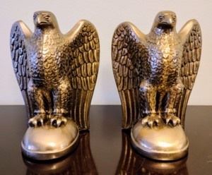 Brass Eagle Bookends. The finish on one is crackled as pictured. Each measures 4.5” wide and 6.5” high.