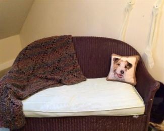 Antique small wicker sofa, needlepoint dog pillow